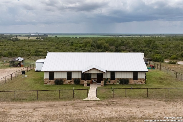 view of front of property with a rural view and an outbuilding