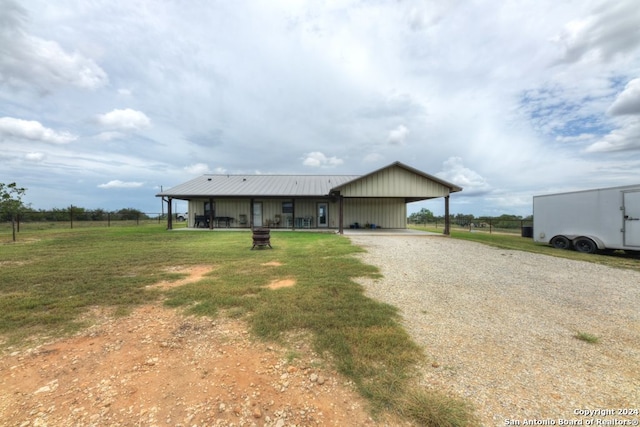 ranch-style house featuring a carport and a front lawn