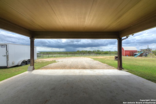 view of patio with a shed and a playground