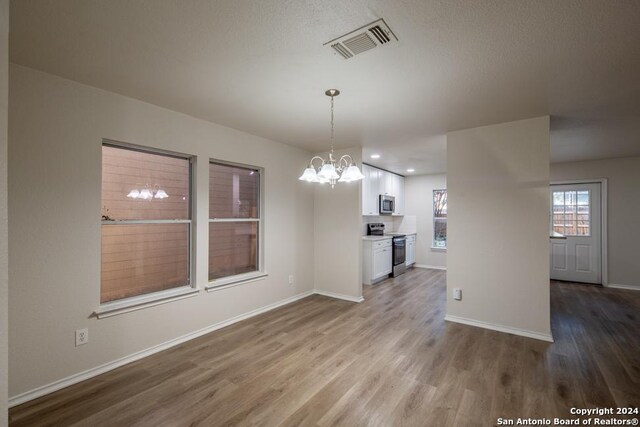 interior space featuring an inviting chandelier and hardwood / wood-style floors