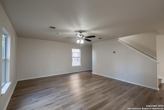 empty room with ceiling fan and wood-type flooring