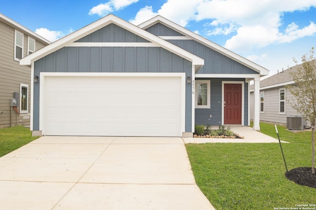 view of front of house with a garage, a front lawn, and central AC