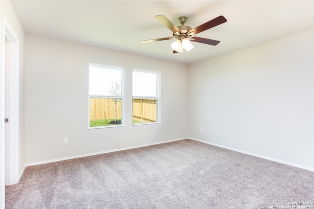 spare room with ceiling fan and carpet flooring