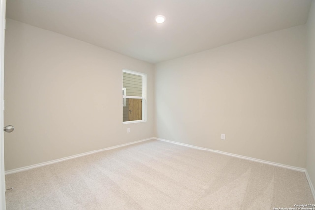 empty room featuring light colored carpet