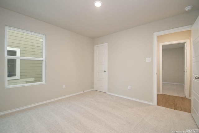 unfurnished room with light carpet