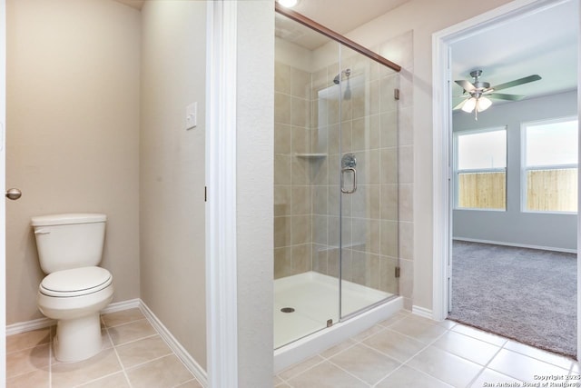 bathroom with toilet, tile patterned floors, ceiling fan, and an enclosed shower