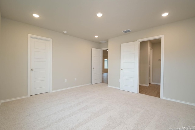 unfurnished bedroom featuring light colored carpet