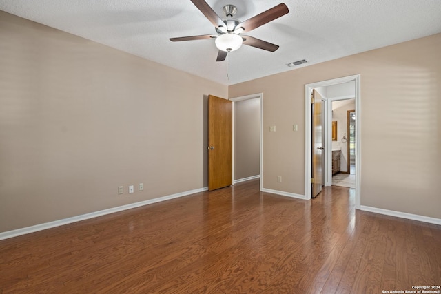 unfurnished bedroom with hardwood / wood-style floors, a textured ceiling, and ceiling fan