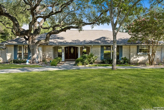 ranch-style home with a front lawn