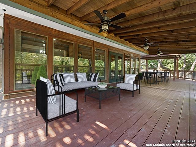 wooden deck featuring outdoor lounge area and ceiling fan