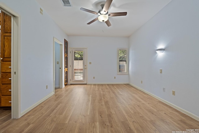 spare room with ceiling fan and light wood-type flooring