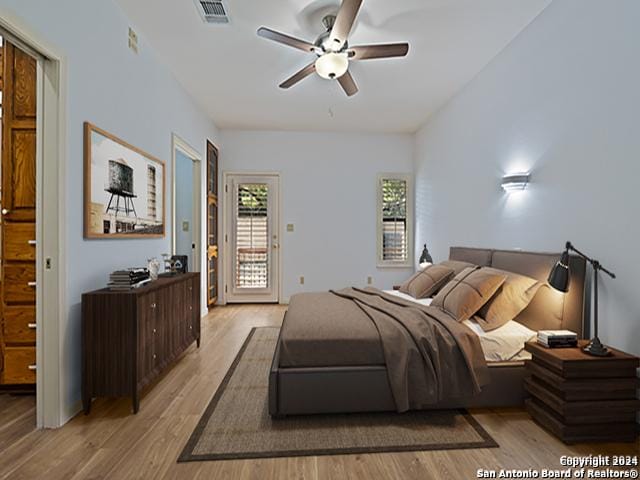 bedroom with access to exterior, ceiling fan, and light hardwood / wood-style flooring