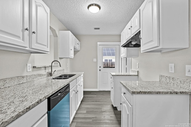 kitchen featuring visible vents, light stone counters, dishwashing machine, white cabinetry, and a sink