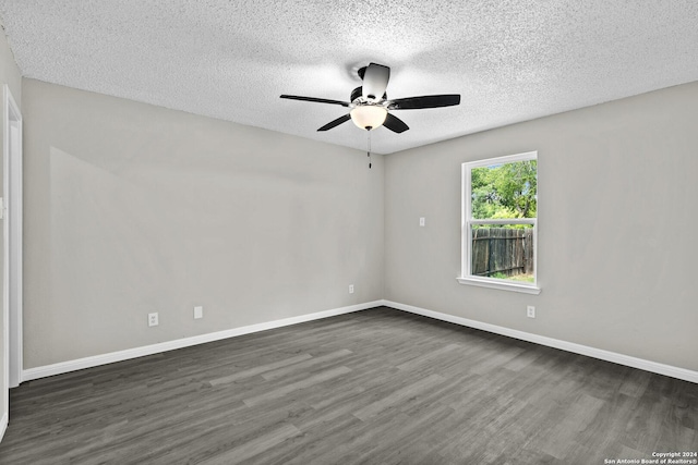 spare room with ceiling fan, baseboards, dark wood-style flooring, and a textured ceiling