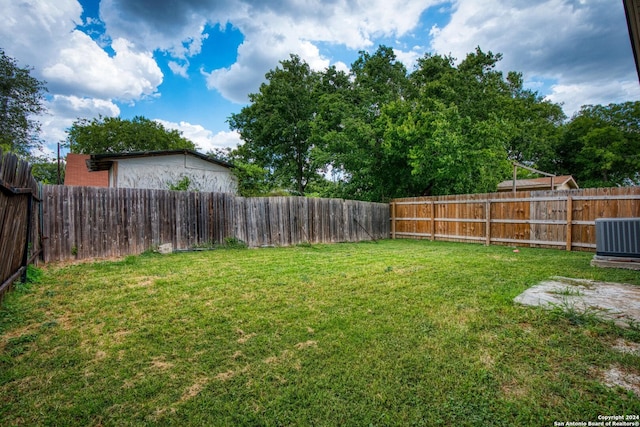 view of yard with cooling unit and a fenced backyard