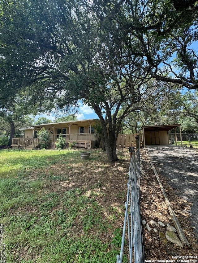 view of yard with a porch and a carport