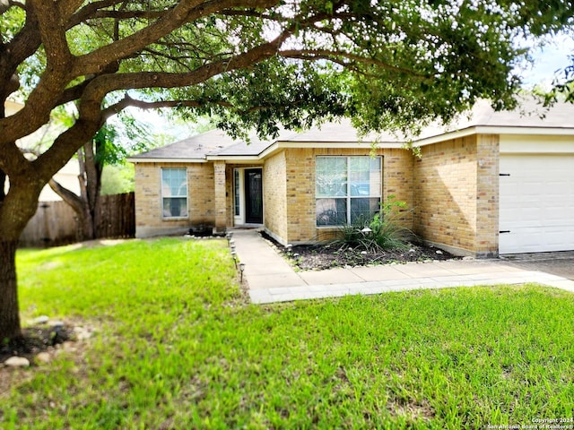 ranch-style home featuring a garage and a front lawn