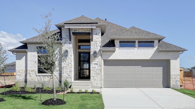 view of front of property with a garage and a front lawn