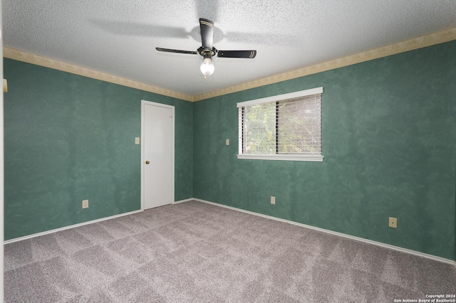 unfurnished room featuring ceiling fan, carpet floors, and a textured ceiling