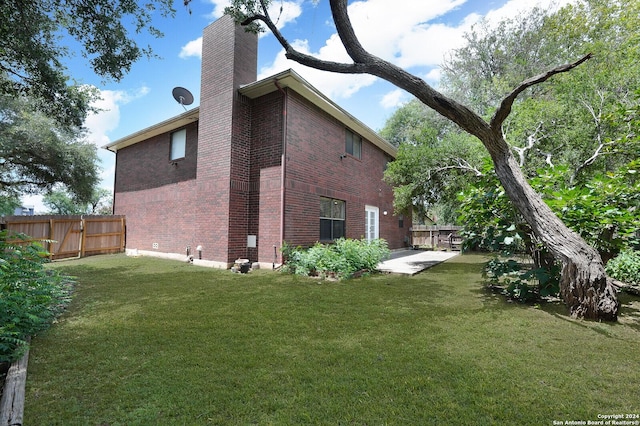 view of home's exterior featuring a yard and a patio area