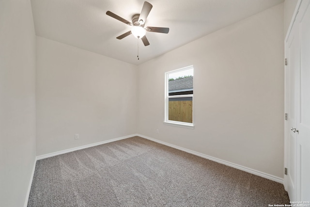 empty room with a ceiling fan, baseboards, and carpet floors