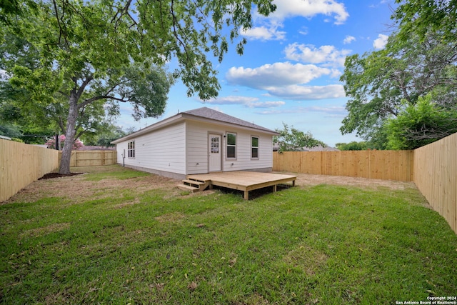 view of yard with a fenced backyard and a deck