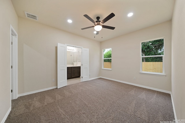 unfurnished bedroom featuring ceiling fan, connected bathroom, and carpet floors