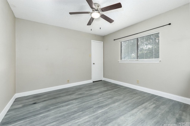 unfurnished room with a ceiling fan, a textured ceiling, baseboards, and wood finished floors