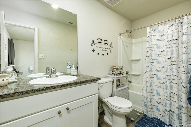 full bathroom featuring vanity, shower / bathtub combination with curtain, and toilet