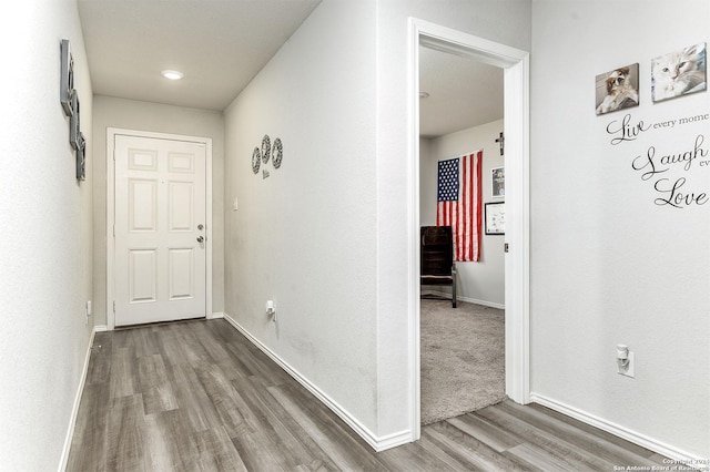 hall with hardwood / wood-style flooring