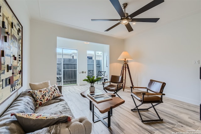 living room featuring ceiling fan and light hardwood / wood-style floors