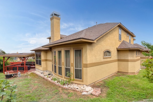 1007 Boulder Cyn, San Antonio, TX 78260 - back of house featuring stucco siding, a chimney, and a lawn