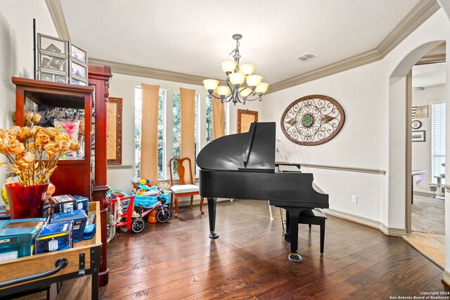 misc room with a notable chandelier, ornamental molding, and dark hardwood / wood-style floors