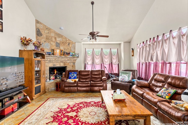 living room with a stone fireplace, ceiling fan, high vaulted ceiling, and light tile patterned floors