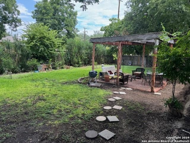 view of yard featuring an outdoor fire pit and a pergola