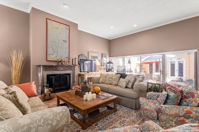 living room featuring a high end fireplace and ornamental molding