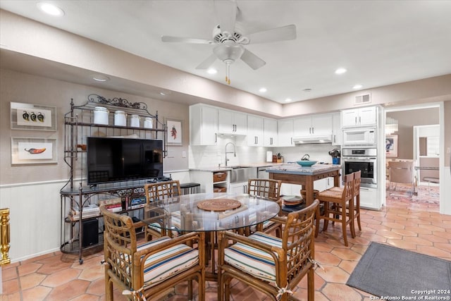 tiled dining room with sink and ceiling fan