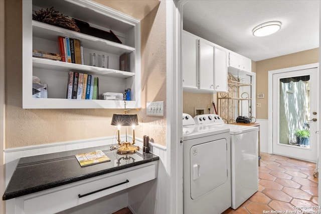 laundry area featuring light tile patterned flooring, washer and clothes dryer, and cabinets