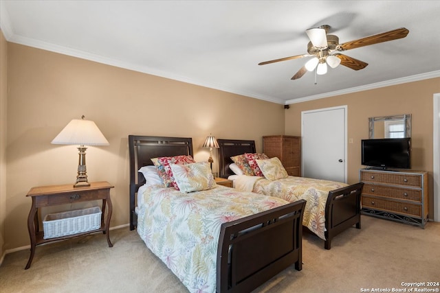 carpeted bedroom featuring ornamental molding and ceiling fan