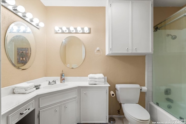 full bathroom with toilet, vanity, and tiled shower / bath