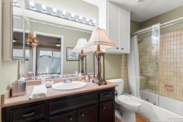 full bathroom featuring shower / bath combo, a textured ceiling, toilet, vanity, and ceiling fan