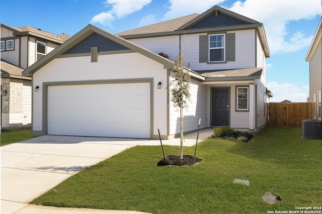 view of property with a garage, central air condition unit, and a front lawn