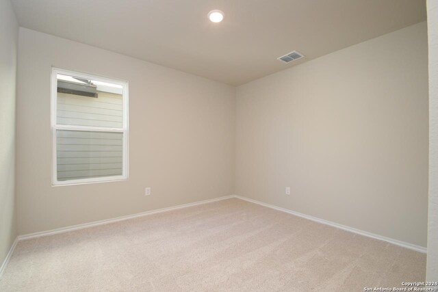 empty room with light colored carpet