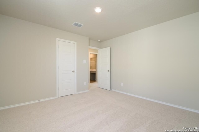 empty room with light colored carpet