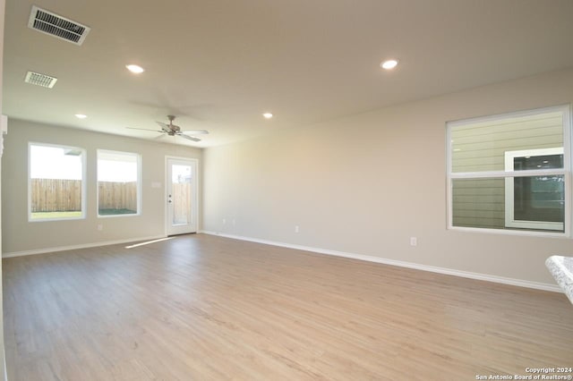 empty room with ceiling fan and light wood-type flooring