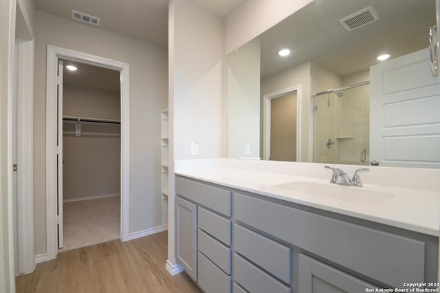 bathroom with vanity, hardwood / wood-style flooring, and an enclosed shower