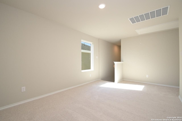 unfurnished room featuring light carpet