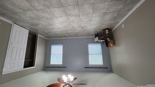 interior space featuring ceiling fan, crown molding, and plenty of natural light