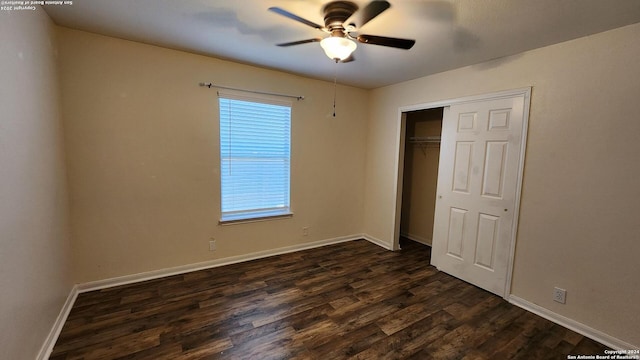 unfurnished bedroom featuring a closet, dark wood-style flooring, baseboards, and a ceiling fan