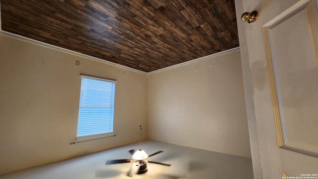 spare room featuring wooden ceiling, ornamental molding, and ceiling fan